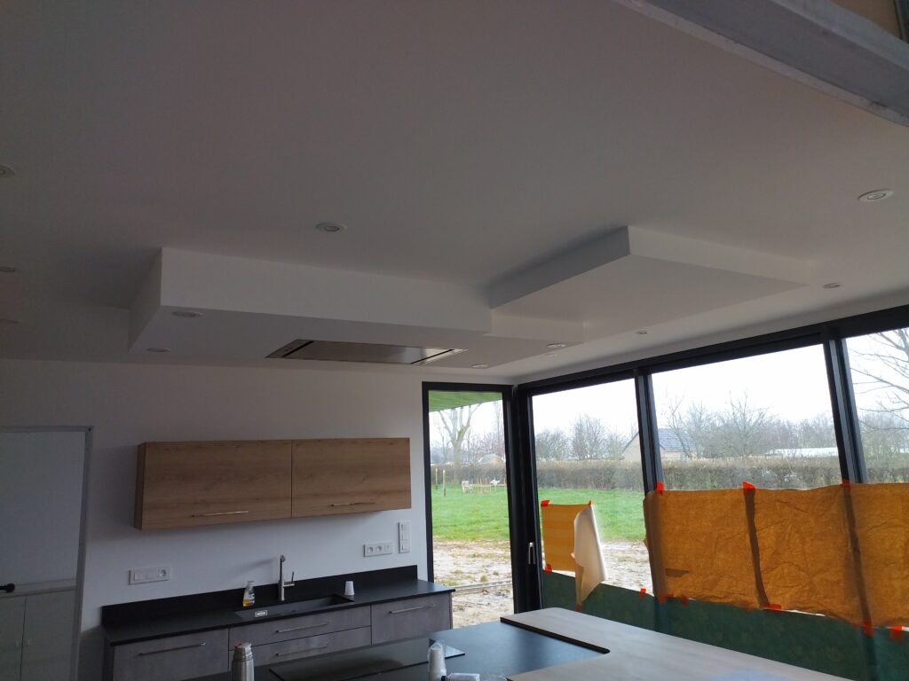 Création de plafond décoratif avec retombées en placo dans un séjour, finitions soignées et éclairage intégré.