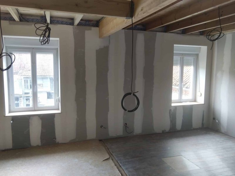 Isolation biosourcée en cours de pose dans une pièce : ossature apparente et préparation des parois avant fermeture et finitions.